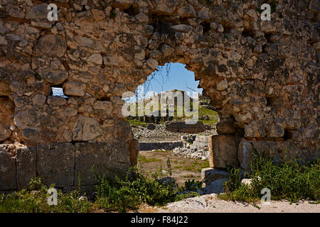 View of hill top fortress through a rubble arch, Tlos Turkey. Stock Photo