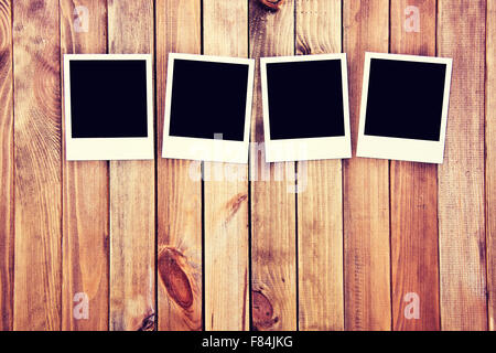 Instant blank polaroid photos frames on wooden background. Free copyspace. Vintage retro concept. Stock Photo