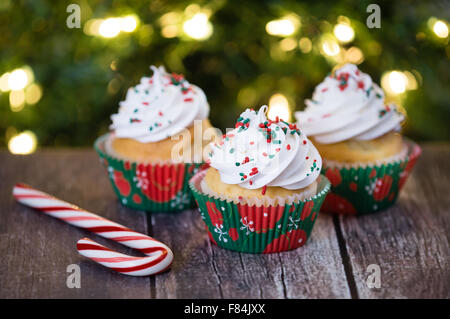 Christmas cupcakes with red and green sprinkles on rustic table Stock Photo
