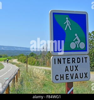 Sign prohibiting use by horses on the adjacent track provided for walkers and cyclists adjacent to the Roman Pont Julien bridge Stock Photo