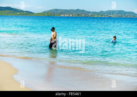 People learn to snorkel off Turtle Beach on Buck Island National park with St. Croix, U.S. Virgin Islands in the background. USVI, U.S.V.I. Stock Photo
