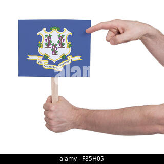 Hand holding small card, isolated on white - Flag of Connecticut Stock Photo