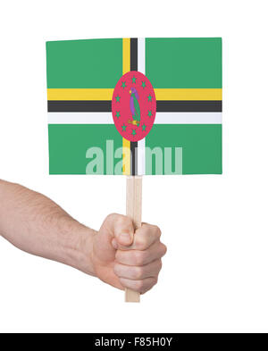 Hand holding small card, isolated white - Flag of Dominica Stock Photo