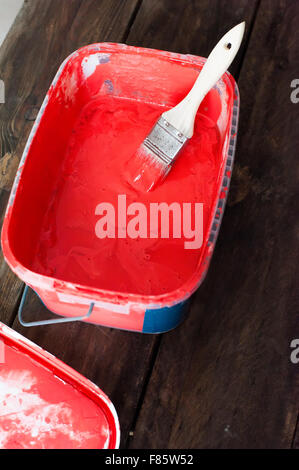 Red paint in a bucket Stock Photo