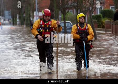 Cumbria Floods. 6th December 2015. RNLI rescue team volunteer wading through Carlisle city centre. Storm Desmond caused severe flooding in Carlisle and across Cumbria. Warwick Road, Carlisle, Cumbria, England, UK. Credit:  Andrew Findlay/Alamy Live News Stock Photo