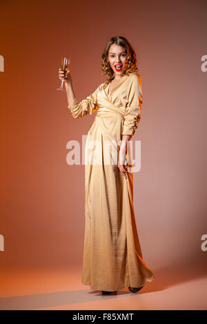 Elegant Woman in Golden Dress with wineglass