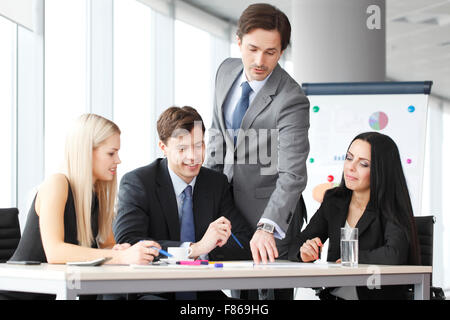 Teamwork of business people discussing reports in office Stock Photo