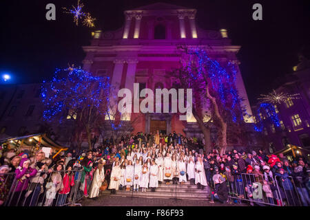 (151206) -- LJUBLJANA, December 6, 2015 (Xinhua) -- A choir of girls dressed as St. Nicholas's angels sings on the steps of the Franciscan Church of the Annunciation in Preseren Square during the annual St. Nicholas procession in Ljubljana, Slovenia, Dec. 5, 2015. The first of three good men (St.Nicholas, Santa Claus and Father Frost), who arrive in December, visited children and their families on the eve of St. Nicholas day. In the annual St. Nicholas procession in the old city center of Ljubljana, Slovenia's capital, performers dressed as St. Nicholas, his angels and devils and parkelj (Slov Stock Photo