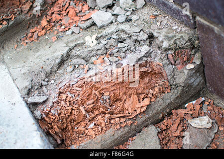 Crumbling red and grey bricks on a pedestrian staircase showing signs of damage Stock Photo