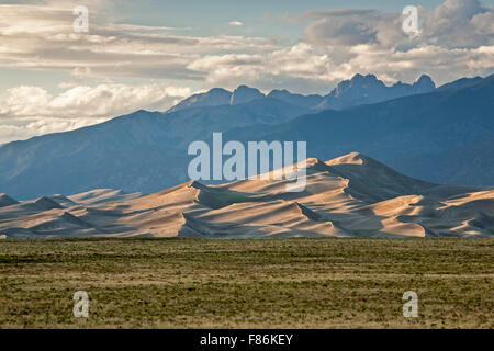 Grass, dunes and Sangre de Cristo Mountains, Great Sand Dunes National Park and Preserve, Colorado USA Stock Photo