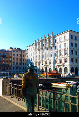 Trieste Italy, view of S. Antonio Canal with life size statue of James Joyce from behind. Stock Photo