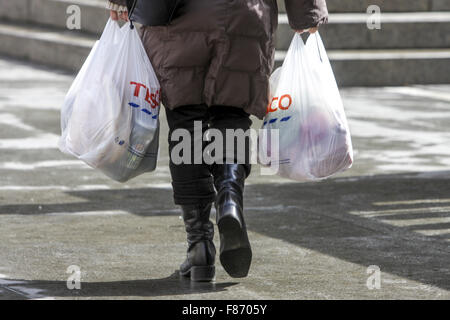 Purchase in plastic bags Tesco bag Store, Shopping bags from the supermarket plastic bags woman walk away Stock Photo