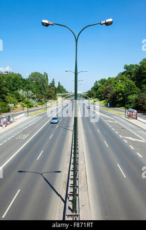 4 lane city road with a bus lane (Aleja Armii Ludowej, Warsaw, Poland) Stock Photo