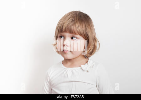 Little blond Caucasian girl over white background, studio portrait Stock Photo