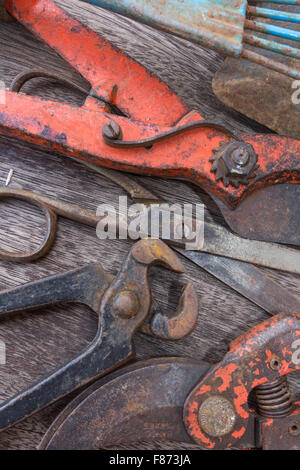 Old rusty tools - vintage tools closeup on wooden background Stock Photo