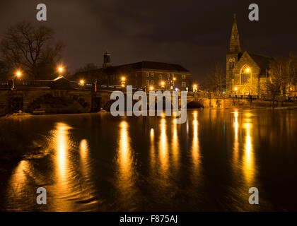 Lights on English Bridge reflected on the swollen River Severn in Shrewsbury, Shropshire. Stock Photo