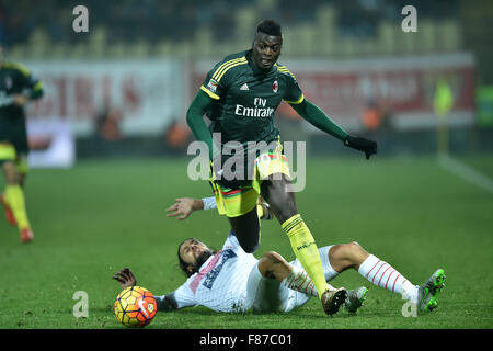 Modena, Italy. 6th Dec, 2015. Mbaye Niang (Top) of AC Milan is tackled by Cristian Zaccardo of Carpi during their Italian Serie A football match at the Braglia stadium in Modena, Italy, Dec. 6, 2015. The match ended with a 0-0 draw. Credit:  Alberto Lingria/Xinhua/Alamy Live News Stock Photo