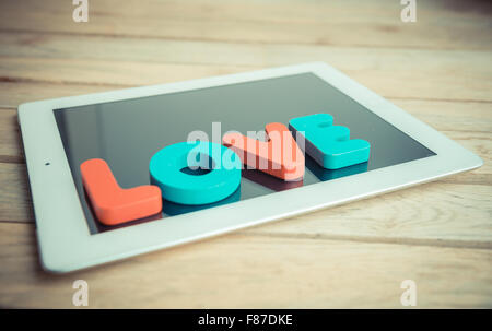 Wooden word LOVE on tablet in vintage style Stock Photo