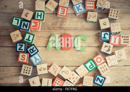 ABC word in wooden block alphabet lay on wooden floor in circle shape Stock Photo