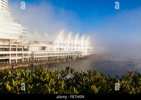 Canada Place Convention Centre and cruise ship dock in early morning fog Stock Photo