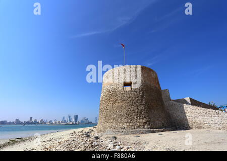 Bu Maher Fort, Muharraq, the start of Bahrain's Pearling Trail, with Manama in the background, Kingdom of Bahrain Stock Photo