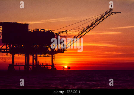 Offshore oil drilling rig with rising sun, Philippines, South East Asia