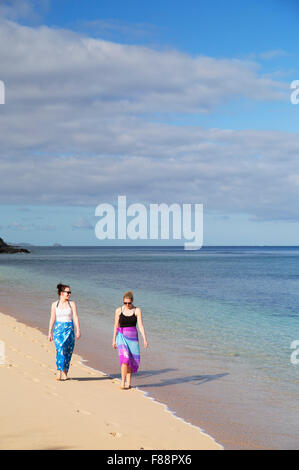 Women walking on beach at Octopus Resort, Waya Island, Yasawa Islands, Fiji (MR) Stock Photo