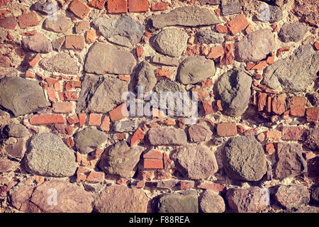 Retro toned old stone and brick wall, background or texture. Stock Photo