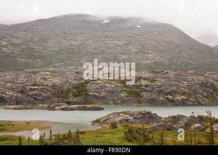 rugged yukon landscape with misty mountains Stock Photo