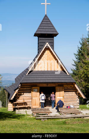 Small wooden chapel with seats outside on Gubalowka Hill, Zakopane, Tatra County, Poland, Europe Stock Photo