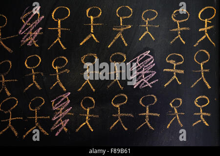 Stick figures written on a blackboard in chalk. Stock Photo