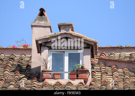 Mansard window in a old style roof Stock Photo