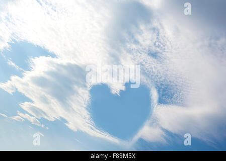 blue sky love heart among white fluffy clouds Stock Photo