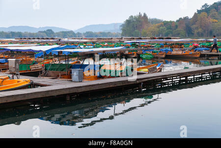 Hangzhou, China - December 4, 2014: Traditional Chinese wooden recreation boats floats moored on the West Lake, famous park Stock Photo