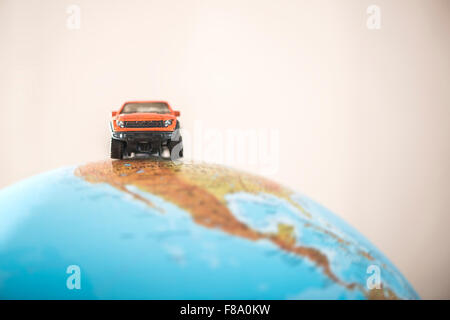 Offroad car on globe. Miniature concept Stock Photo