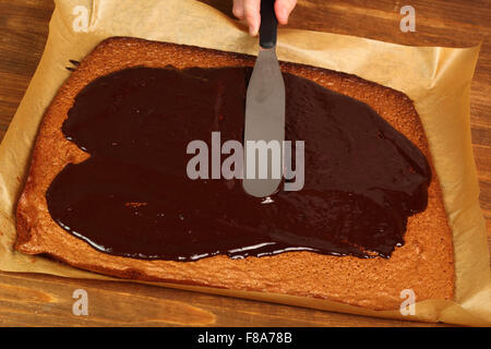 Leveling icing using palette knife. Making Chocolate Brownie. Series. Stock Photo