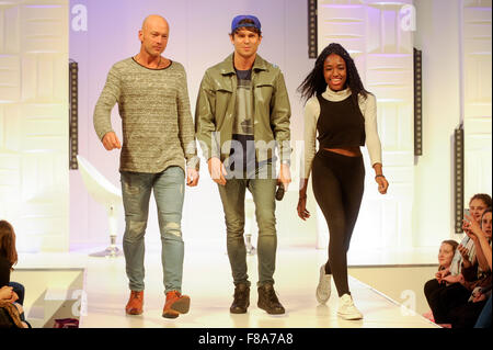 Joey Essex on the catwalk with two audience members at Clothes Show Live, NEC, Birmingham, UK, 7th December 2015. Joey wears items from his own Fusey fashion range. Credit:  Antony Nettle/Alamy Live News Stock Photo