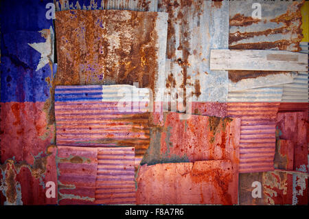 An abstract background image of the flag of Chile painted on to rusty corrugated iron sheets overlapping to form a wall or fence Stock Photo
