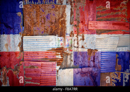 An abstract background image of the flag of Dominican Republic painted on to rusty corrugated iron sheets overlapping Stock Photo