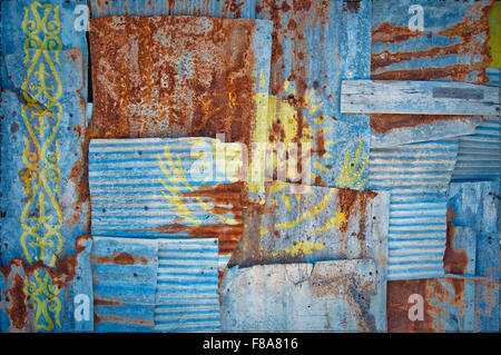 An abstract background image of the flag of Kazakhstan painted on to rusty corrugated iron sheets overlapping to form a wall Stock Photo