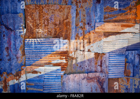An abstract background image of the flag of Marshall Islands painted on to rusty corrugated iron sheets overlapping Stock Photo