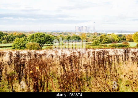 Fiddlers Ferry Power Station in the distance through the haze viewed across fields from Daresbury Firs Stock Photo