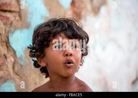small cuban boy on the street in front of an old wall, street scene in the old town of Trinidad, Trinidad, Cuba, Sancti Spíritus Stock Photo