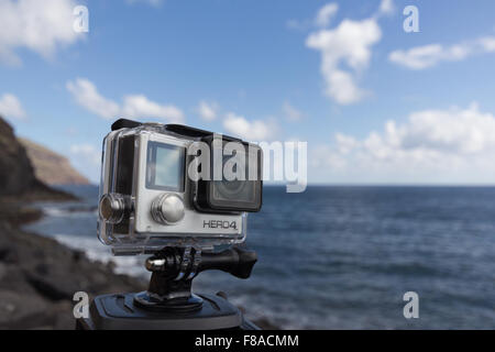 Shot of GoPro Hero 4 Black on tripod with ocean background. Stock Photo