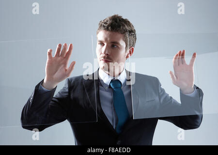Business man touching two transparent screens Stock Photo