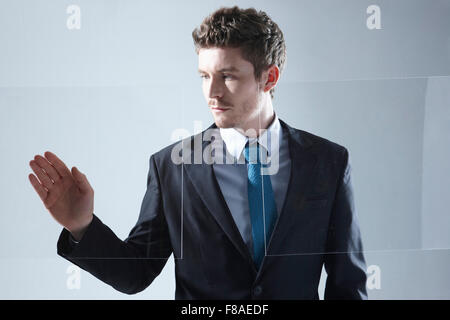 Business man working on touch screen with one hand Stock Photo