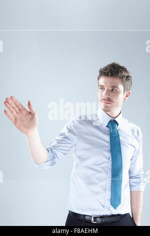 Man touching a transparent screen with his hand Stock Photo