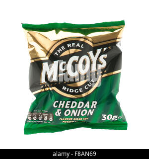 Packet of Cheddar and Onion McCoy Ridge Cut Crisps on a white background, McCoy's are made by KP Snacks in the UK Stock Photo