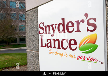 A logo sign outside the headquarters of Snyder's-Lance, Inc., in Charlotte, North Carolina on November 28, 2015. Stock Photo