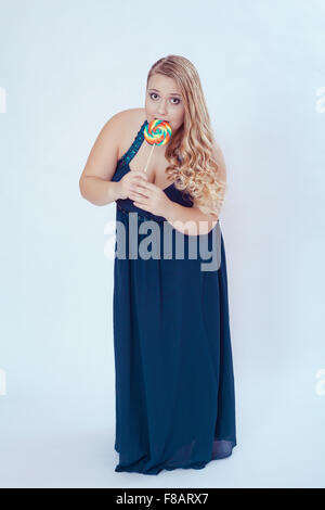 Fat Woman in Blue Dress Eating Lollipop Stock Photo